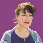 Professional headshot of Sue Smith, a hypnotherapist, wearing a navy blue blouse and silver jewelry against a purple background. Photographed by Laura Pearman Creative.