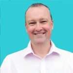 A professional headshot of Richard Tubb, an MSP expert, smiling in a white shirt against a bright turquoise background.